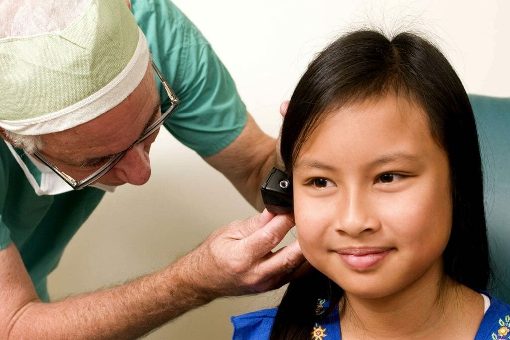A young girl receives an otolaryngologist examination during a well child check in Sugar Land.