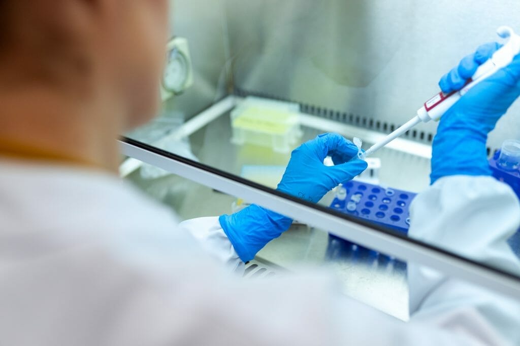 A person in a lab coat conducting a well child check.