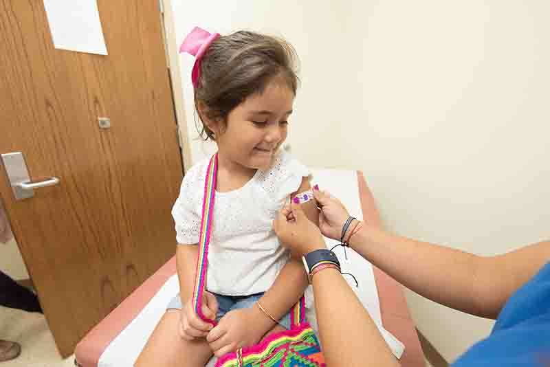 A young girl receiving a vaccine at a Pediatrician's office in Sugar Land.
