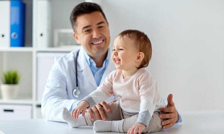 Keywords: baby, doctor. 

Description: A baby is being seen by a pediatrician.