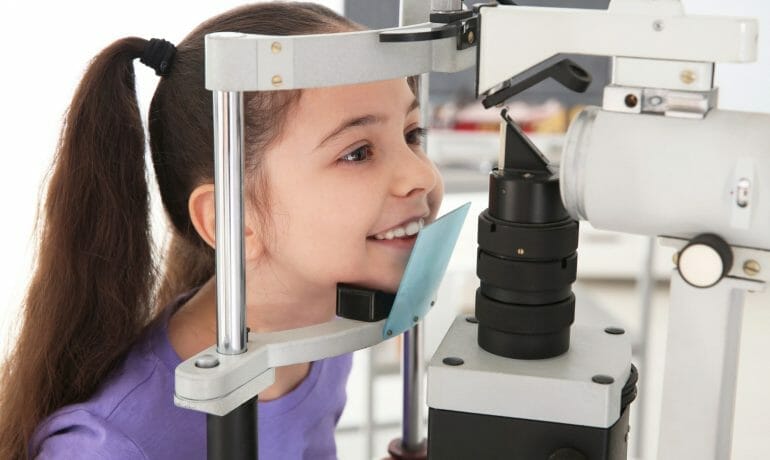 A young girl receiving an eye exam.