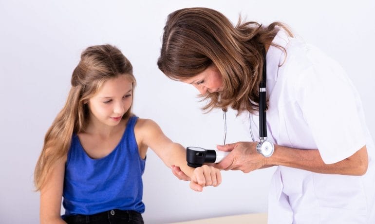 A young girl is being examined by a doctor.
